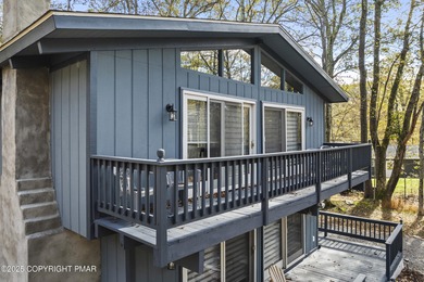 Tucked beneath a canopy of whispering trees, this modern chalet on Pocono Farms Country Club in Pennsylvania - for sale on GolfHomes.com, golf home, golf lot