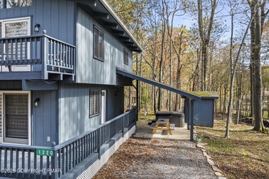Tucked beneath a canopy of whispering trees, this modern chalet on Pocono Farms Country Club in Pennsylvania - for sale on GolfHomes.com, golf home, golf lot