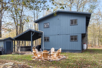 Tucked beneath a canopy of whispering trees, this modern chalet on Pocono Farms Country Club in Pennsylvania - for sale on GolfHomes.com, golf home, golf lot