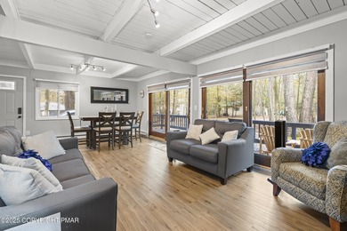 Tucked beneath a canopy of whispering trees, this modern chalet on Pocono Farms Country Club in Pennsylvania - for sale on GolfHomes.com, golf home, golf lot