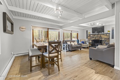 Tucked beneath a canopy of whispering trees, this modern chalet on Pocono Farms Country Club in Pennsylvania - for sale on GolfHomes.com, golf home, golf lot