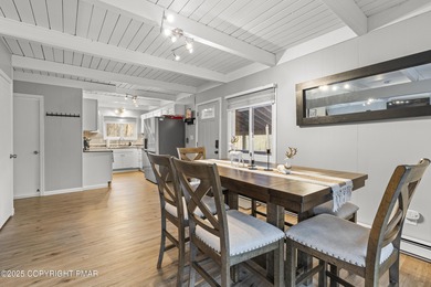 Tucked beneath a canopy of whispering trees, this modern chalet on Pocono Farms Country Club in Pennsylvania - for sale on GolfHomes.com, golf home, golf lot