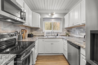 Tucked beneath a canopy of whispering trees, this modern chalet on Pocono Farms Country Club in Pennsylvania - for sale on GolfHomes.com, golf home, golf lot