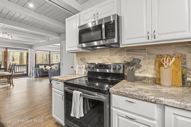 Tucked beneath a canopy of whispering trees, this modern chalet on Pocono Farms Country Club in Pennsylvania - for sale on GolfHomes.com, golf home, golf lot