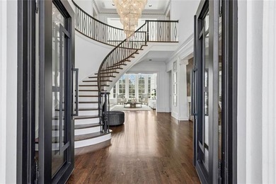 This extraordinary estate in the prestigious Windward community on The Golf Club of Georgia in Georgia - for sale on GolfHomes.com, golf home, golf lot