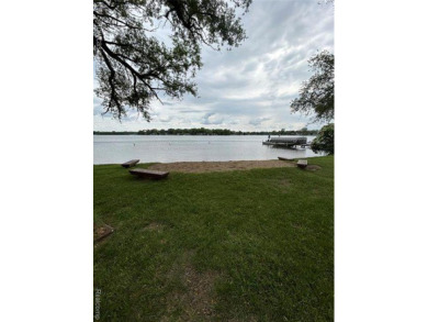 Two bedroom bungalow between Duck Lake and White Lake on a wide on Highland Hills Golf Course in Michigan - for sale on GolfHomes.com, golf home, golf lot