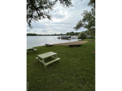 Two bedroom bungalow between Duck Lake and White Lake on a wide on Highland Hills Golf Course in Michigan - for sale on GolfHomes.com, golf home, golf lot