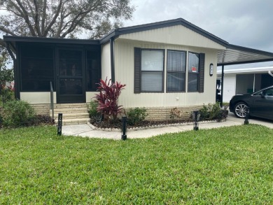 THIS SPECTACULAR 2/2 WITH A 12 X 24 SCREEN ROOM IS SELLING FOR on Lake Henry Golf Club in Florida - for sale on GolfHomes.com, golf home, golf lot