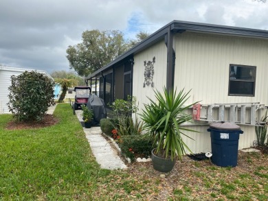 THIS SPECTACULAR 2/2 WITH A 12 X 24 SCREEN ROOM IS SELLING FOR on Lake Henry Golf Club in Florida - for sale on GolfHomes.com, golf home, golf lot