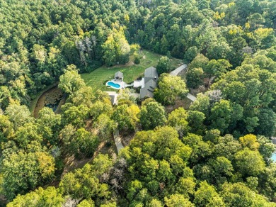 Welcome to a sophisticated retreat with a lodge-inspired charm on Quail Hallow Golf Course in Mississippi - for sale on GolfHomes.com, golf home, golf lot