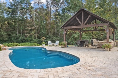 Welcome to a sophisticated retreat with a lodge-inspired charm on Quail Hallow Golf Course in Mississippi - for sale on GolfHomes.com, golf home, golf lot