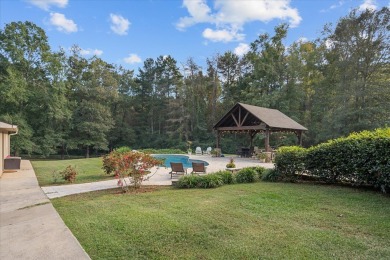 Welcome to a sophisticated retreat with a lodge-inspired charm on Quail Hallow Golf Course in Mississippi - for sale on GolfHomes.com, golf home, golf lot