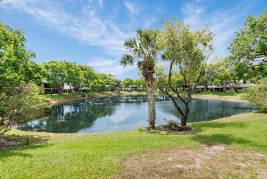Enjoy serene water views from this light and bright first-floor on Hunters Run Golf and Country Club in Florida - for sale on GolfHomes.com, golf home, golf lot