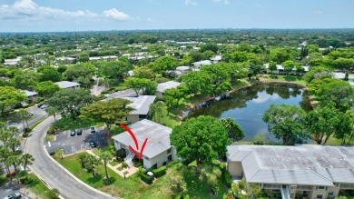 Enjoy serene water views from this light and bright first-floor on Hunters Run Golf and Country Club in Florida - for sale on GolfHomes.com, golf home, golf lot