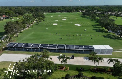 Enjoy serene water views from this light and bright first-floor on Hunters Run Golf and Country Club in Florida - for sale on GolfHomes.com, golf home, golf lot