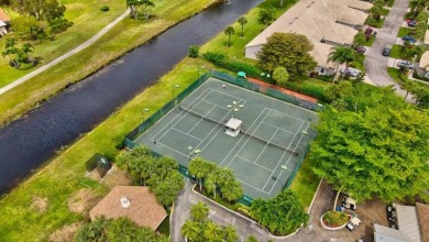 Magnificent lake view 2 bedroom, 2 bathroom, 2 car garage home on Boca Delray Golf and Country Club in Florida - for sale on GolfHomes.com, golf home, golf lot