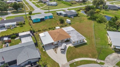 CHARMING MID-CENTURY HOME IN A QUIET CUL-DE-SAC WITH WATER VIEWS on Port Charlotte Golf Club in Florida - for sale on GolfHomes.com, golf home, golf lot