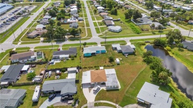 CHARMING MID-CENTURY HOME IN A QUIET CUL-DE-SAC WITH WATER VIEWS on Port Charlotte Golf Club in Florida - for sale on GolfHomes.com, golf home, golf lot