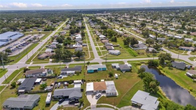 CHARMING MID-CENTURY HOME IN A QUIET CUL-DE-SAC WITH WATER VIEWS on Port Charlotte Golf Club in Florida - for sale on GolfHomes.com, golf home, golf lot