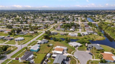 CHARMING MID-CENTURY HOME IN A QUIET CUL-DE-SAC WITH WATER VIEWS on Port Charlotte Golf Club in Florida - for sale on GolfHomes.com, golf home, golf lot