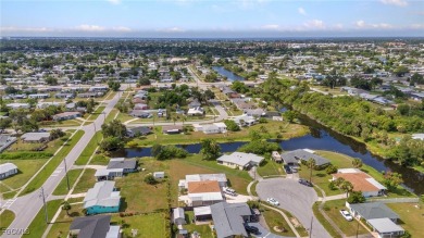 CHARMING MID-CENTURY HOME IN A QUIET CUL-DE-SAC WITH WATER VIEWS on Port Charlotte Golf Club in Florida - for sale on GolfHomes.com, golf home, golf lot