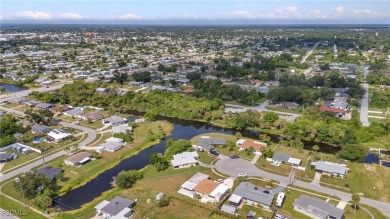 CHARMING MID-CENTURY HOME IN A QUIET CUL-DE-SAC WITH WATER VIEWS on Port Charlotte Golf Club in Florida - for sale on GolfHomes.com, golf home, golf lot