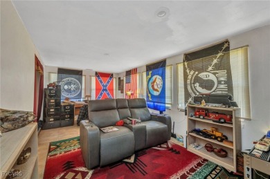 CHARMING MID-CENTURY HOME IN A QUIET CUL-DE-SAC WITH WATER VIEWS on Port Charlotte Golf Club in Florida - for sale on GolfHomes.com, golf home, golf lot