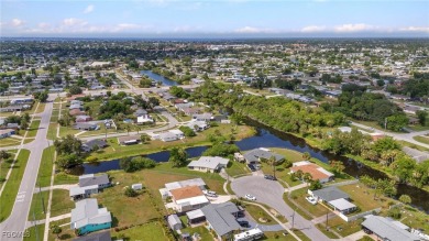 CHARMING MID-CENTURY HOME IN A QUIET CUL-DE-SAC WITH WATER VIEWS on Port Charlotte Golf Club in Florida - for sale on GolfHomes.com, golf home, golf lot
