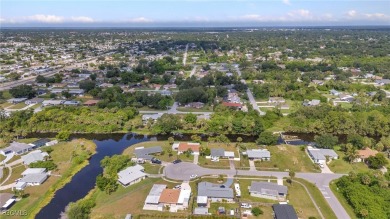 CHARMING MID-CENTURY HOME IN A QUIET CUL-DE-SAC WITH WATER VIEWS on Port Charlotte Golf Club in Florida - for sale on GolfHomes.com, golf home, golf lot