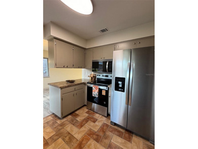 Located on a cul-de-sac, this 2 bedroom home overlooks a on Cypresswood Golf and Country Club in Florida - for sale on GolfHomes.com, golf home, golf lot