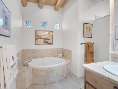 This exceptional adobe-style home, with a stucco exterior and on Taos Country Club in New Mexico - for sale on GolfHomes.com, golf home, golf lot