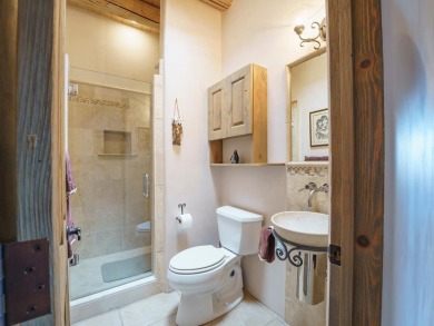 This exceptional adobe-style home, with a stucco exterior and on Taos Country Club in New Mexico - for sale on GolfHomes.com, golf home, golf lot