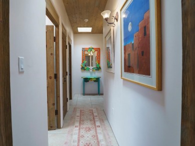This exceptional adobe-style home, with a stucco exterior and on Taos Country Club in New Mexico - for sale on GolfHomes.com, golf home, golf lot