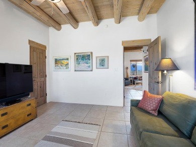 This exceptional adobe-style home, with a stucco exterior and on Taos Country Club in New Mexico - for sale on GolfHomes.com, golf home, golf lot
