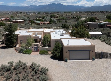 This exceptional adobe-style home, with a stucco exterior and on Taos Country Club in New Mexico - for sale on GolfHomes.com, golf home, golf lot