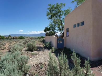 This exceptional adobe-style home, with a stucco exterior and on Taos Country Club in New Mexico - for sale on GolfHomes.com, golf home, golf lot