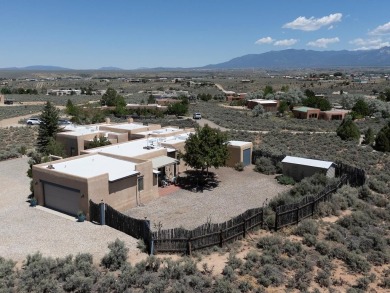 This exceptional adobe-style home, with a stucco exterior and on Taos Country Club in New Mexico - for sale on GolfHomes.com, golf home, golf lot