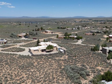 This exceptional adobe-style home, with a stucco exterior and on Taos Country Club in New Mexico - for sale on GolfHomes.com, golf home, golf lot