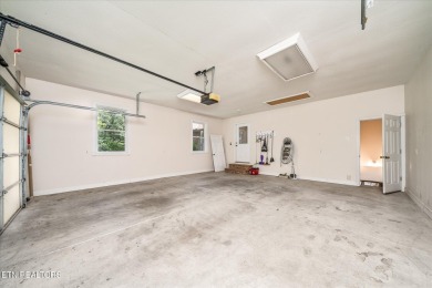 Brick Basement Ranch with two car garage on main level and on Lake Tansi Village Country Club in Tennessee - for sale on GolfHomes.com, golf home, golf lot