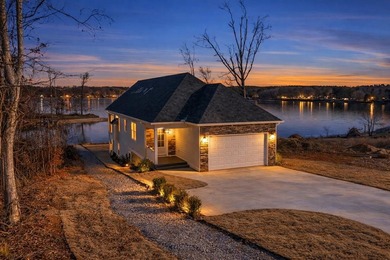 Discover the epitome of lakeside living at 301 Portland Circle on The Links At Stoney Point in South Carolina - for sale on GolfHomes.com, golf home, golf lot