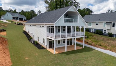 Discover the epitome of lakeside living at 301 Portland Circle on The Links At Stoney Point in South Carolina - for sale on GolfHomes.com, golf home, golf lot