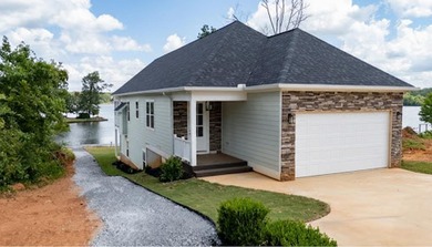 Discover the epitome of lakeside living at 301 Portland Circle on The Links At Stoney Point in South Carolina - for sale on GolfHomes.com, golf home, golf lot