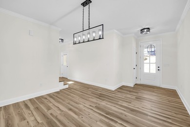 Discover the epitome of lakeside living at 301 Portland Circle on The Links At Stoney Point in South Carolina - for sale on GolfHomes.com, golf home, golf lot