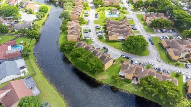 FHA AND LOW DOWNPAYMENT AVAILABLE! CORNER UNIT AND WATERVIEWS on Woodmont Country Club in Florida - for sale on GolfHomes.com, golf home, golf lot