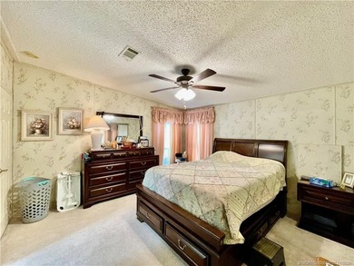 Lovely 2-bedroom, 2 bath home with 2 outdoor living spaces on Indianwood Golf and Country Club in Florida - for sale on GolfHomes.com, golf home, golf lot