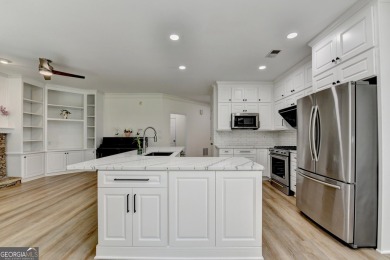 Discover a meticulously designed home that seamlessly blends on Canongate At Olde Atlanta Golf Club in Georgia - for sale on GolfHomes.com, golf home, golf lot