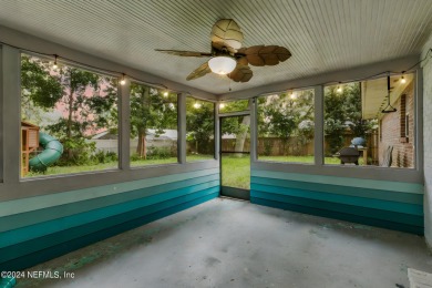 Nestled within a canopy of lush trees, this charming 1960s home on Blue Cypress Golf Club in Florida - for sale on GolfHomes.com, golf home, golf lot