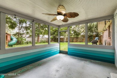 Nestled within a canopy of lush trees, this charming 1960s home on Blue Cypress Golf Club in Florida - for sale on GolfHomes.com, golf home, golf lot