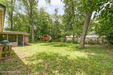 Nestled within a canopy of lush trees, this charming 1960s home on Blue Cypress Golf Club in Florida - for sale on GolfHomes.com, golf home, golf lot