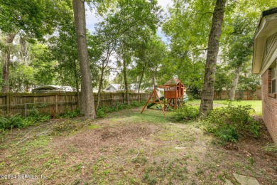 Nestled within a canopy of lush trees, this charming 1960s home on Blue Cypress Golf Club in Florida - for sale on GolfHomes.com, golf home, golf lot